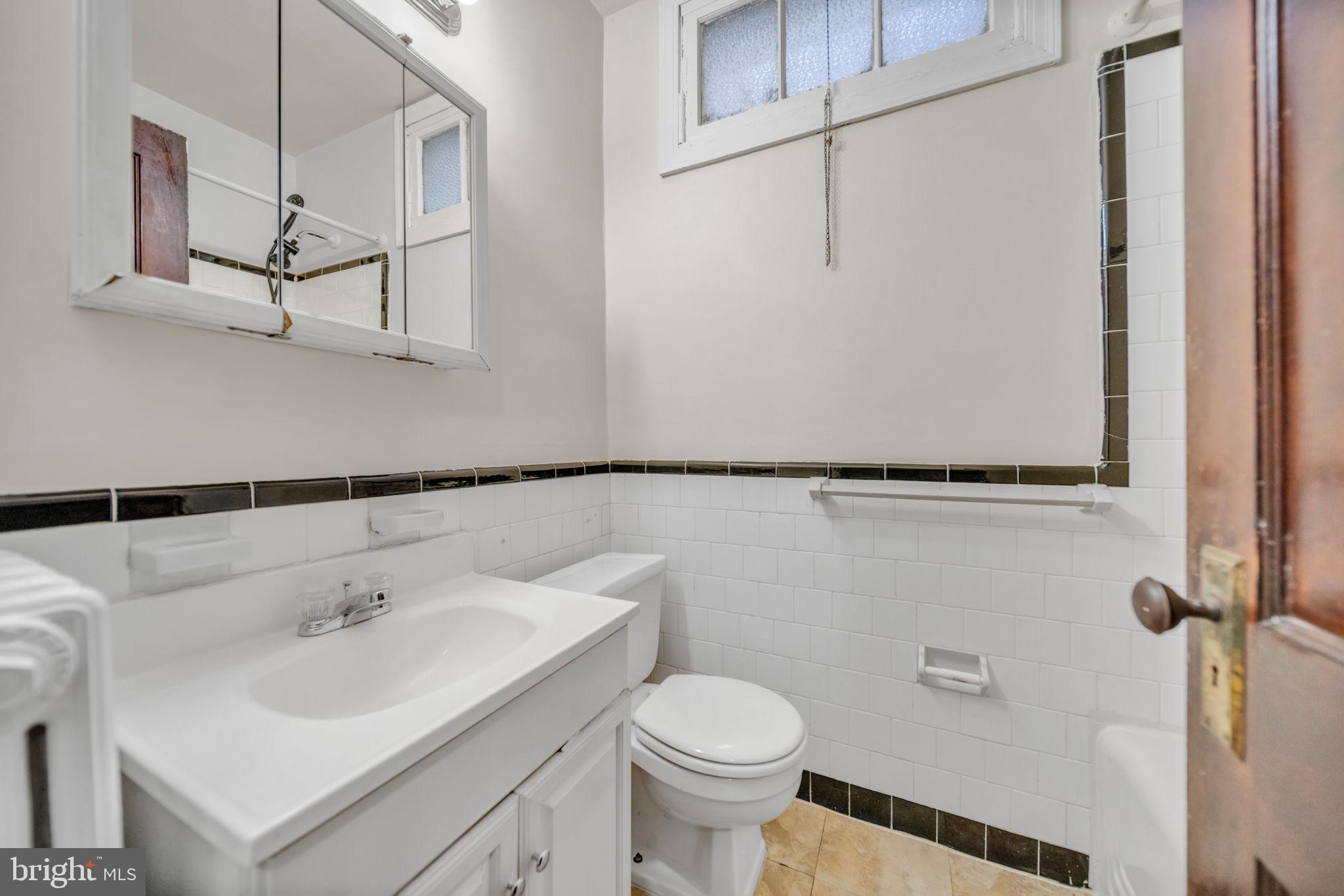 220 21st Street Northeast Washington, DC 20002 - Photo 22 of 26 a bathroom with a sink toilet and vanity