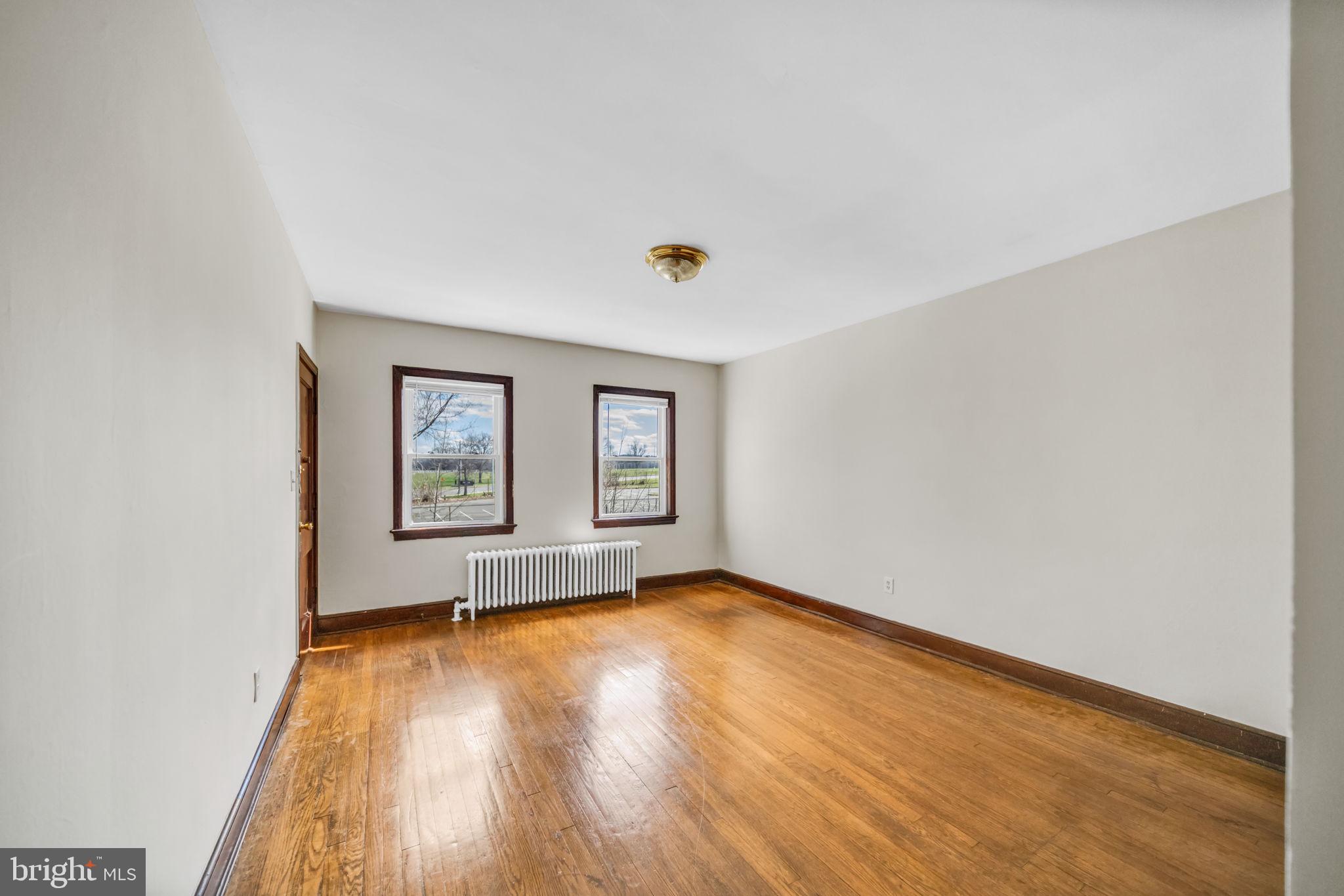 220 21st Street Northeast Washington, DC 20002 - Photo 8 of 26 an empty room with a window and wooden floor