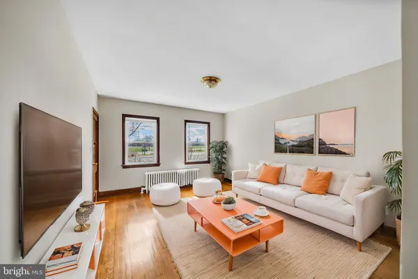 an empty room with a window and wooden floor