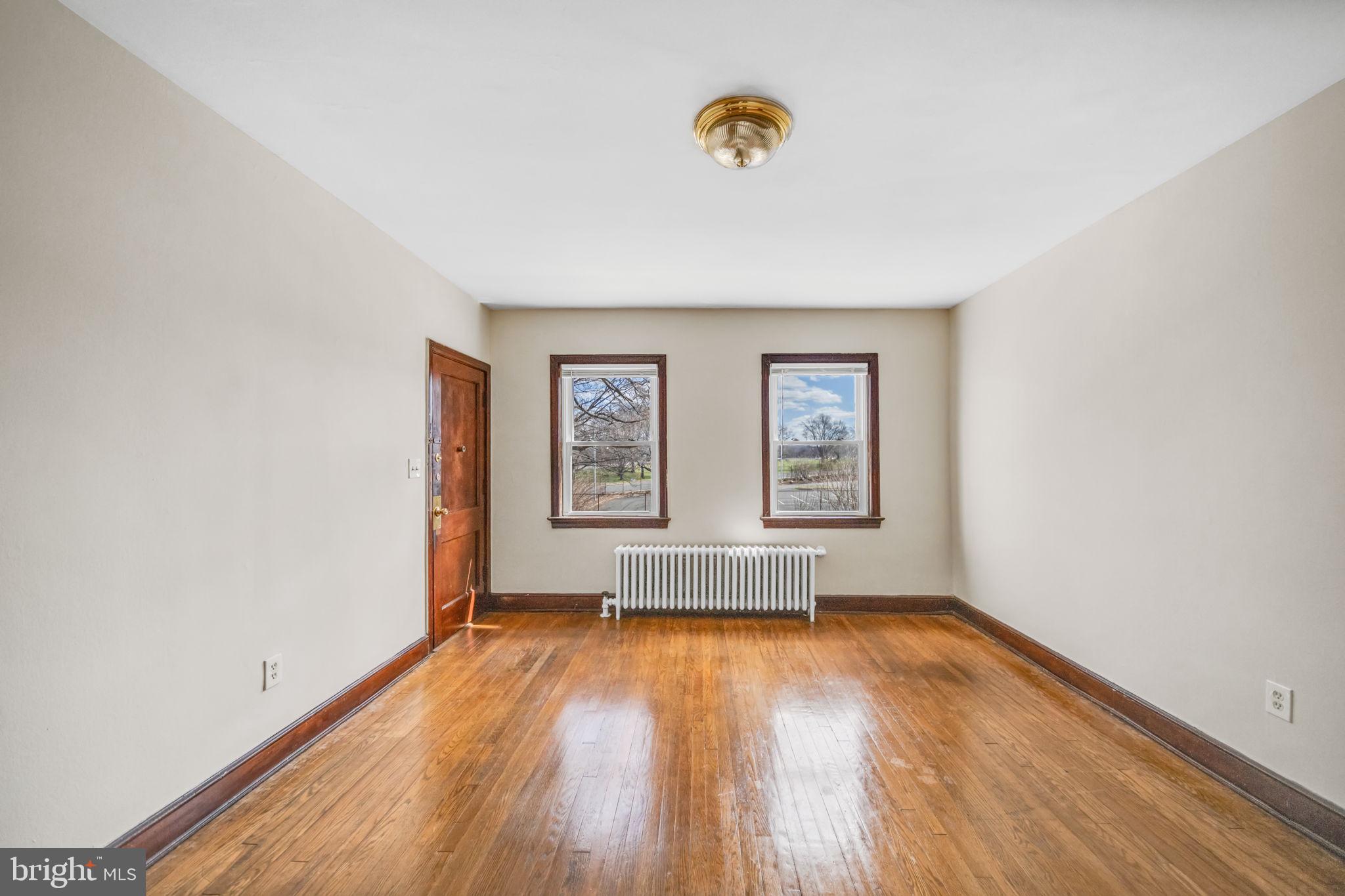 220 21st Street Northeast Washington, DC 20002 - Photo 10 of 26 an empty room with a window and wooden floor