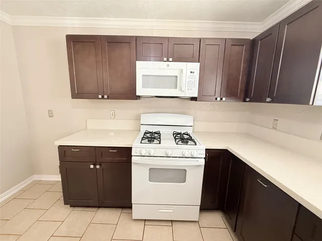 a kitchen with a cabinets and white stove
