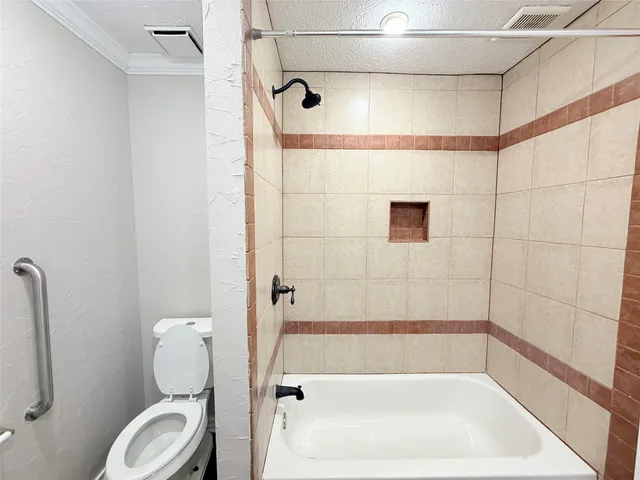 a bathroom with a shower a toilet and a shower