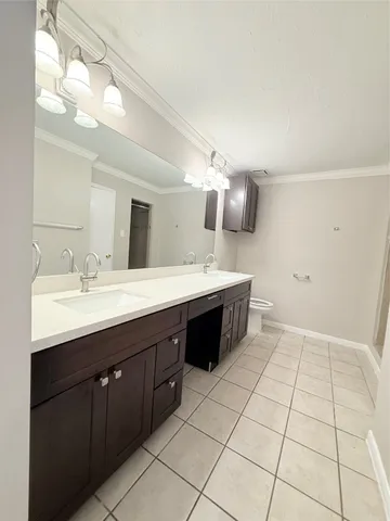 a spacious bathroom with a double vanity sink a mirror and a bathtub