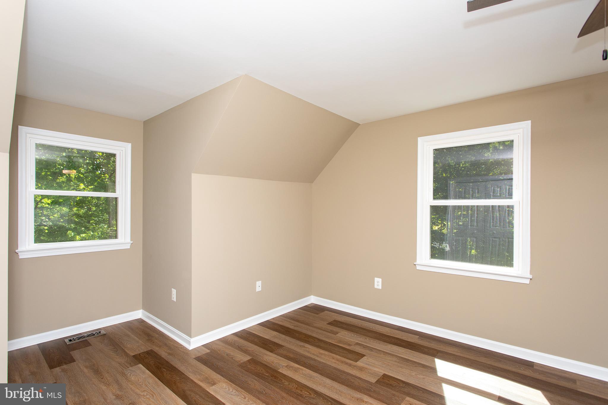 540 Thunderbird Drive Lusby, MD 20657 - Photo 11 of 66 a view of an empty room with wooden floor and a window