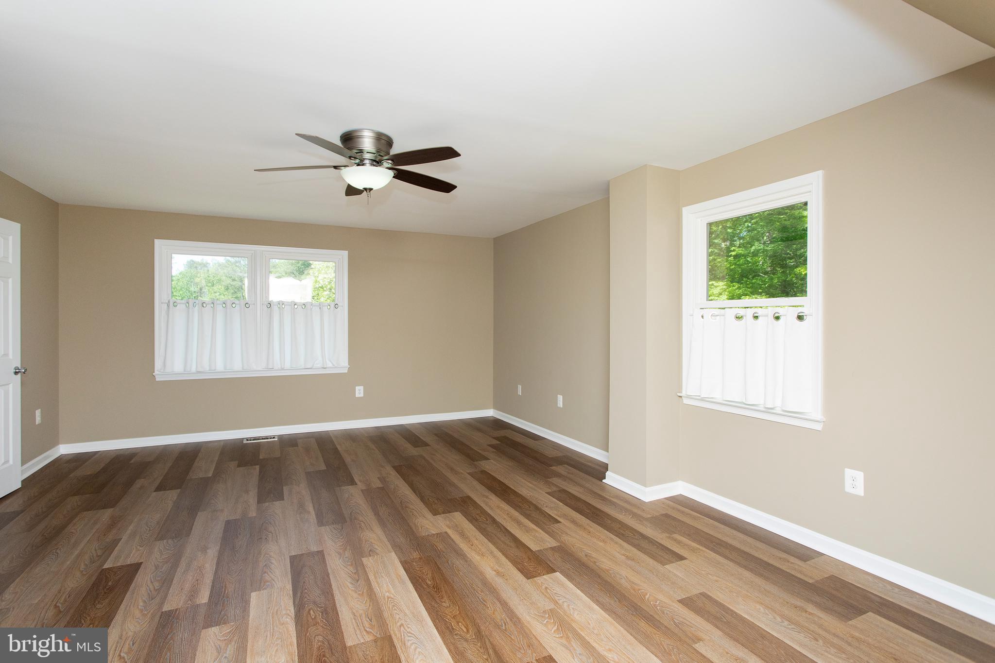 540 Thunderbird Drive Lusby, MD 20657 - Photo 13 of 66 wooden floor in an empty room with a window