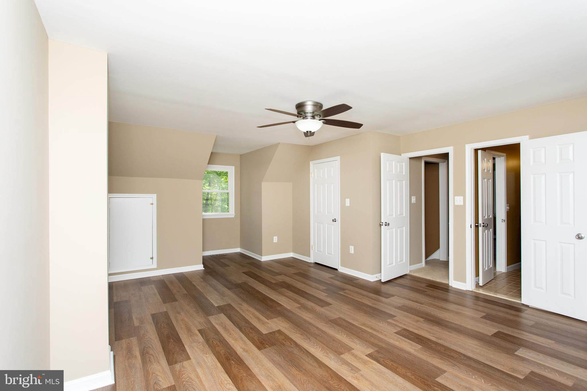 540 Thunderbird Drive Lusby, MD 20657 - Photo 15 of 66 a view of room with wooden floor and ceiling fan