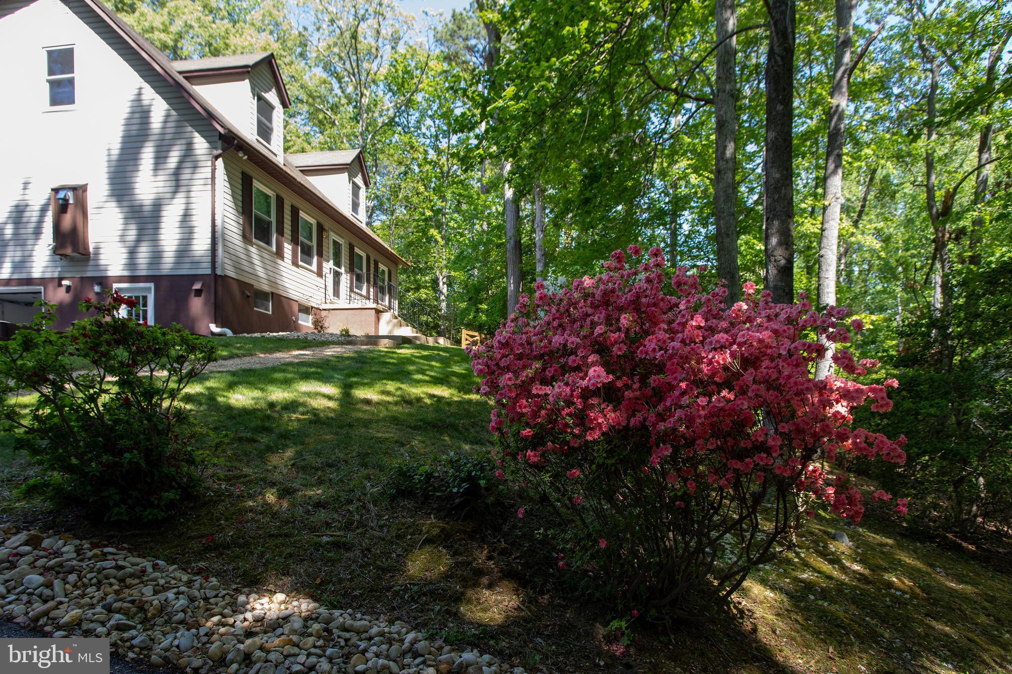 540 Thunderbird Drive Lusby, MD 20657 - Photo 2 of 66 a backyard of a house with lots of green space