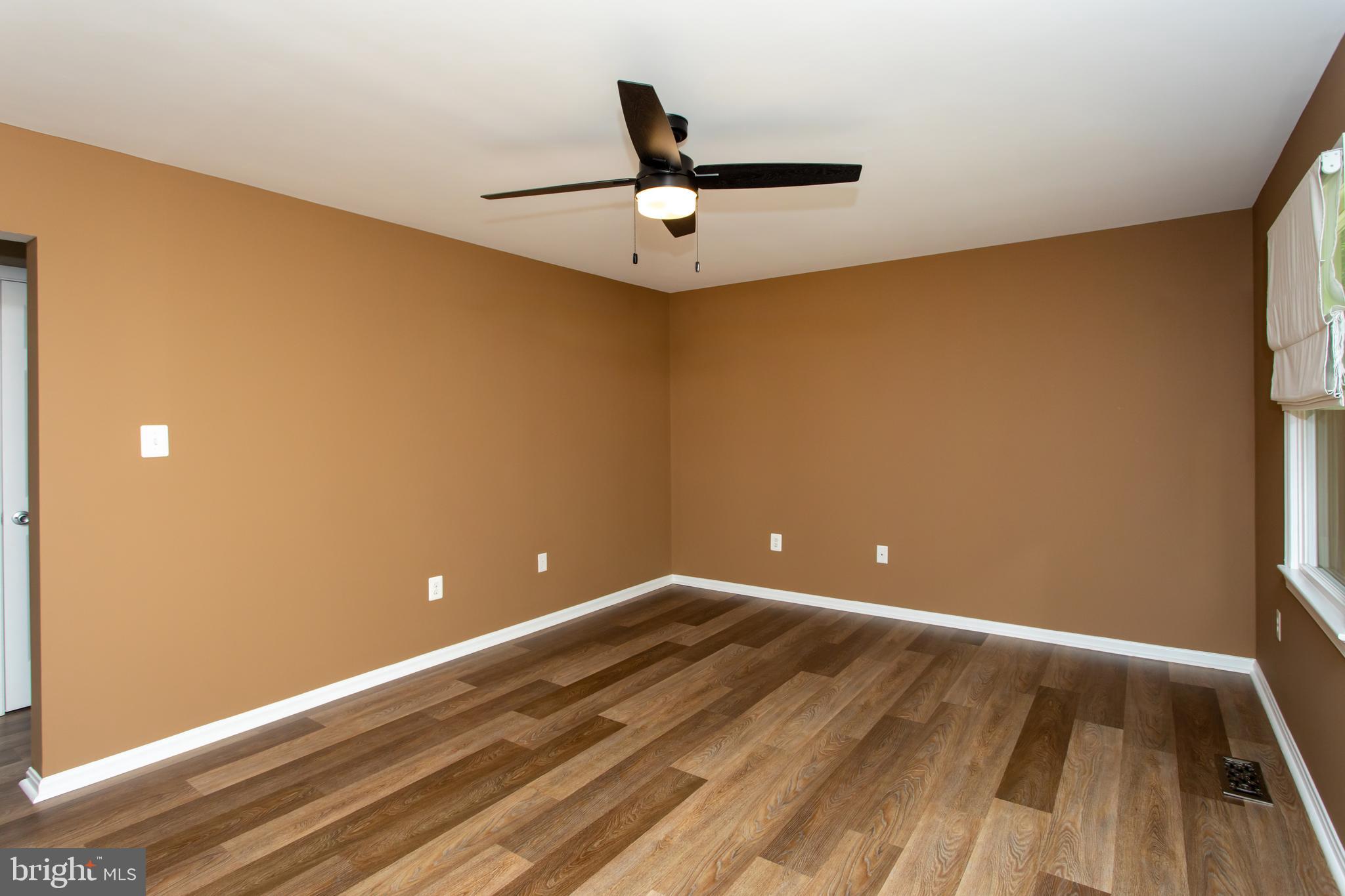540 Thunderbird Drive Lusby, MD 20657 - Photo 22 of 66 a view of room with wooden floor and ceiling fan