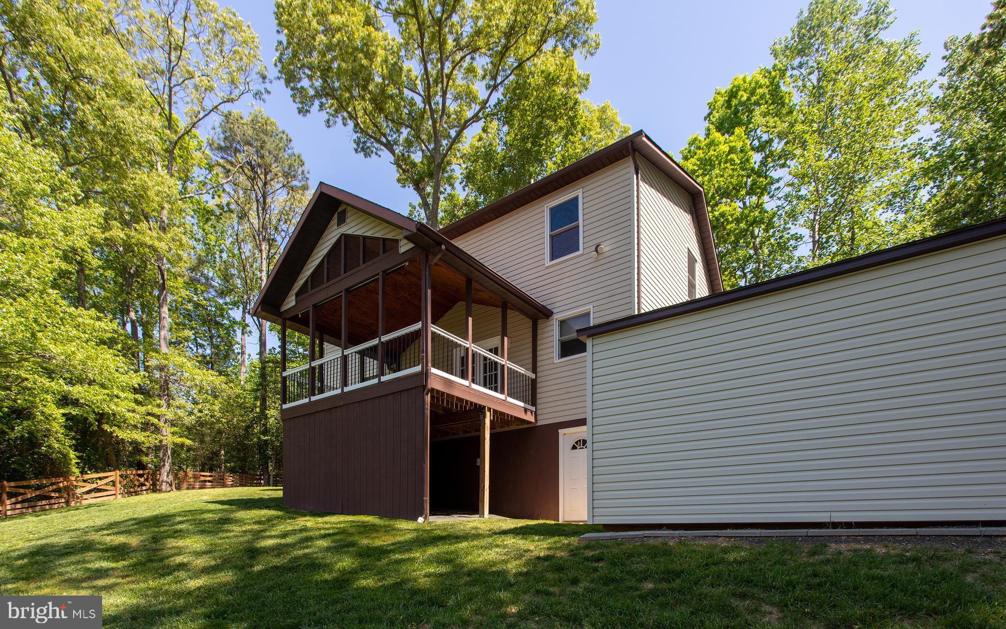 540 Thunderbird Drive Lusby, MD 20657 - Photo 3 of 66 a front view of a house with a yard and garage