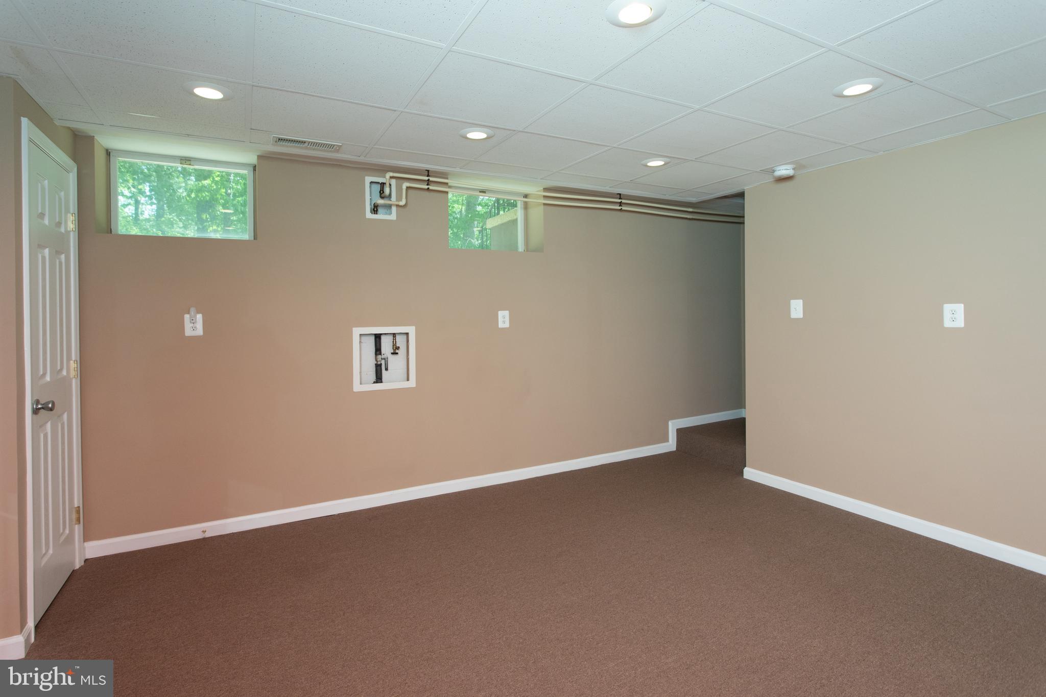 540 Thunderbird Drive Lusby, MD 20657 - Photo 46 of 66 an empty room with wooden floor and windows