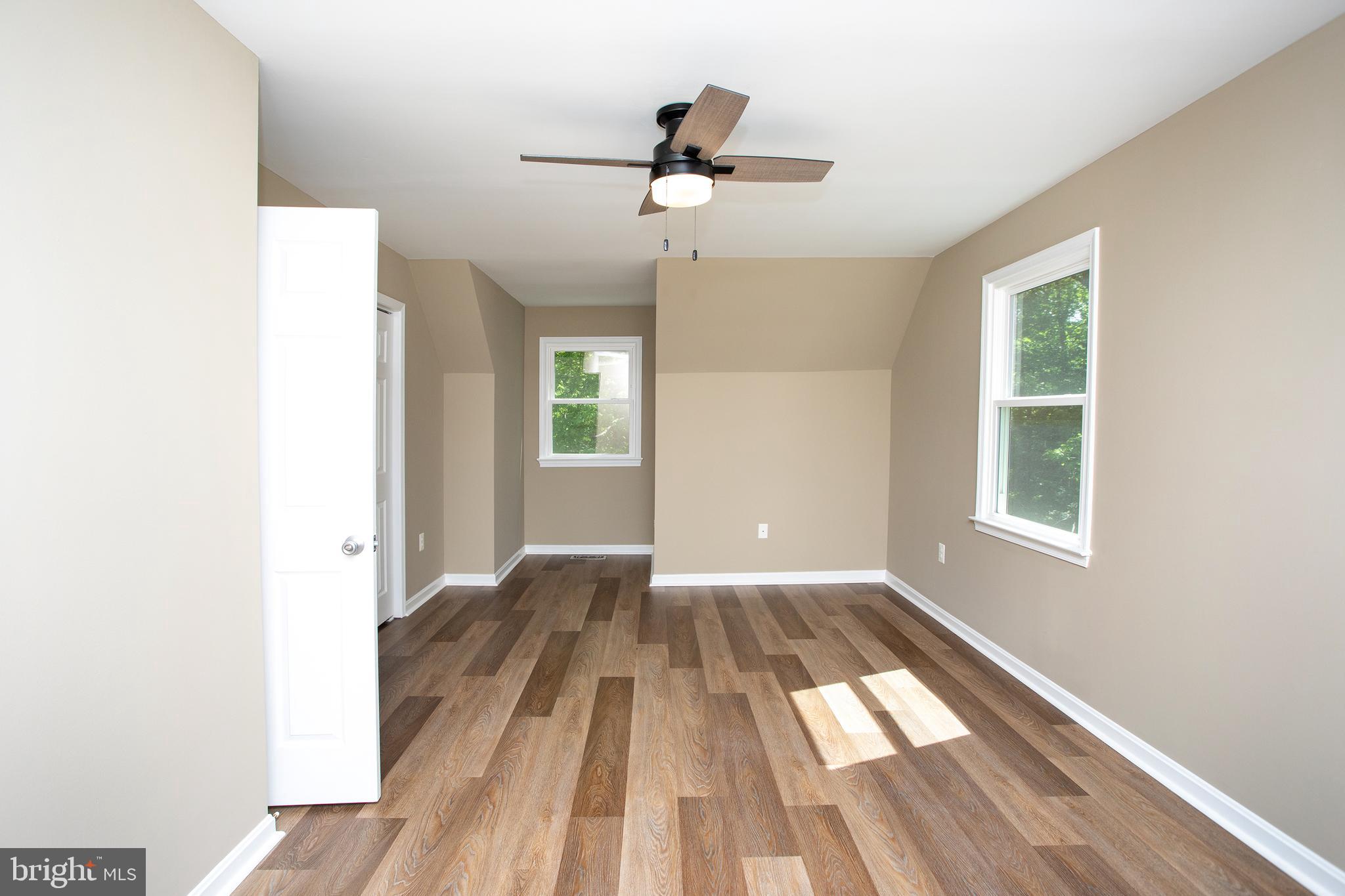 540 Thunderbird Drive Lusby, MD 20657 - Photo 8 of 66 a view of empty room with wooden floor and fan