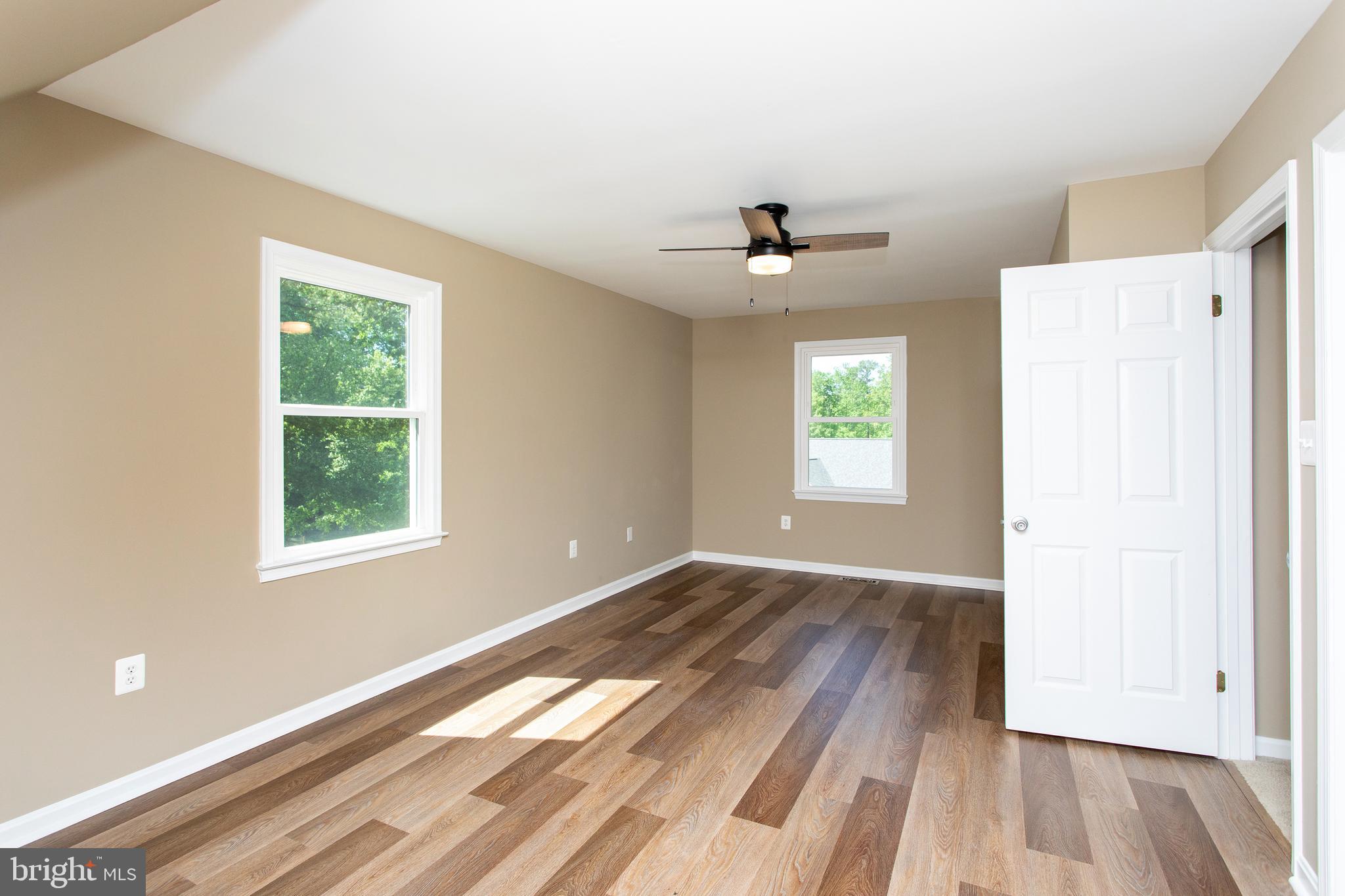 540 Thunderbird Drive Lusby, MD 20657 - Photo 9 of 66 a view of an empty room with wooden floor and a window