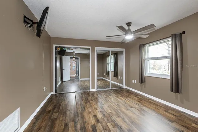 wooden floor in an empty room with a window