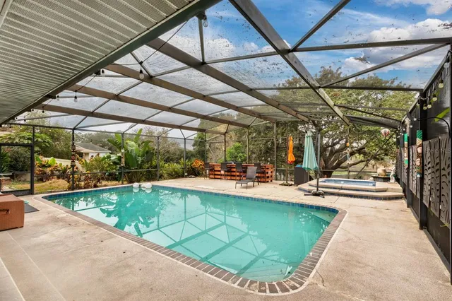 a view of a swimming pool with a patio and yard