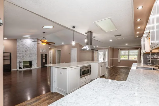 a large kitchen with sink and cabinets