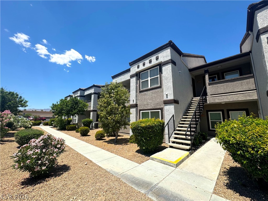 A vibrant exterior showcasing well-maintained landscaping and accessible pathways to residential units.