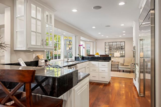 a kitchen with a table chairs stove and cabinets
