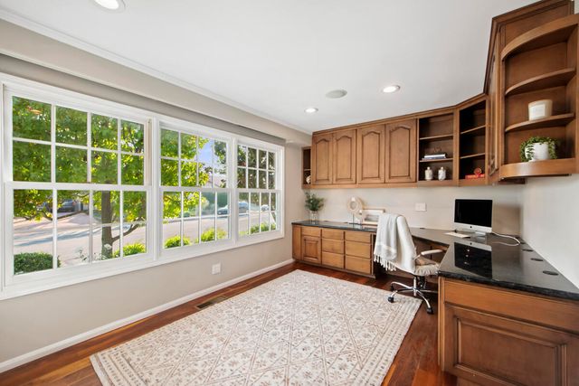 a kitchen with a stove a refrigerator and wooden cabinets