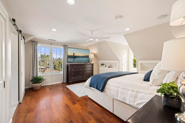 a bedroom with a bed potted plant with the outer view