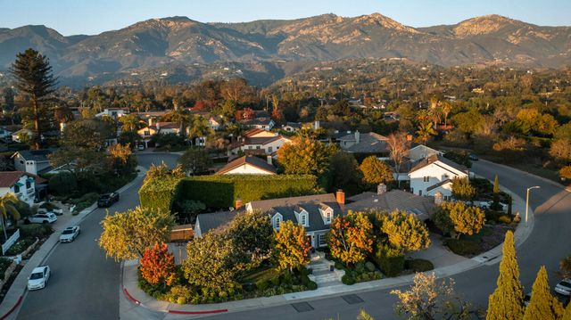 a front view of a house with a yard and fountain