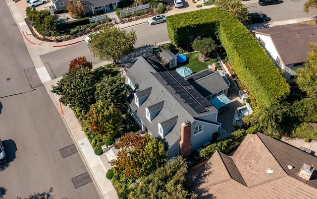 an aerial view of a house with a yard