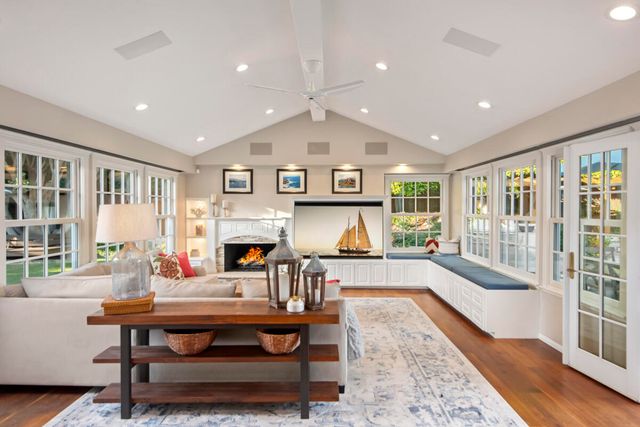 a living room with furniture a fireplace and a table