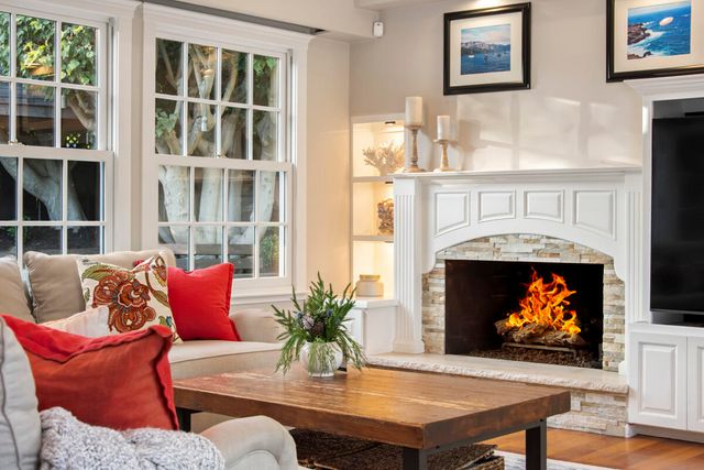 a living room with furniture a fireplace and a flat screen tv
