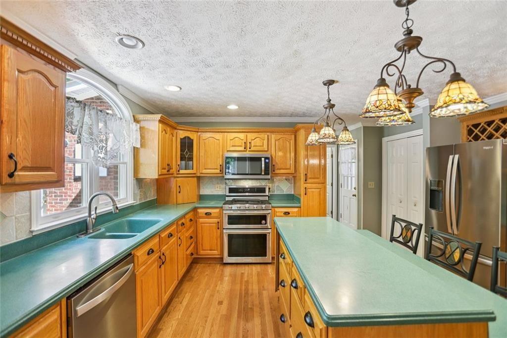 13597 Woolsey Road Hampton, GA 30228 - Photo 21 of 87 a kitchen with stainless steel appliances granite countertop a stove and refrigerator