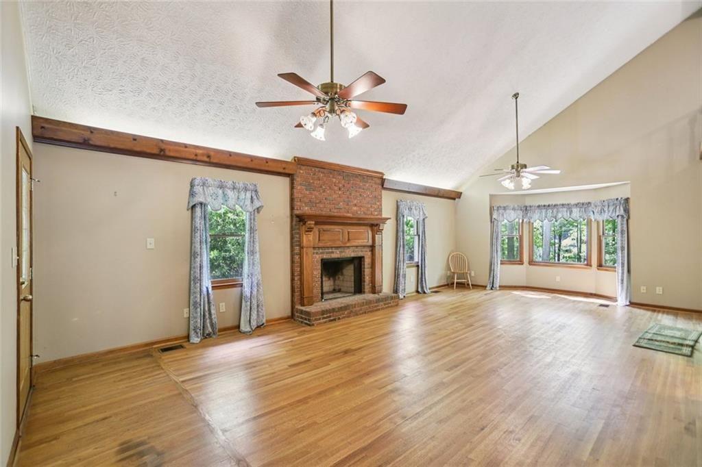 13597 Woolsey Road Hampton, GA 30228 - Photo 7 of 87 a view of an empty room with a window and wooden floor