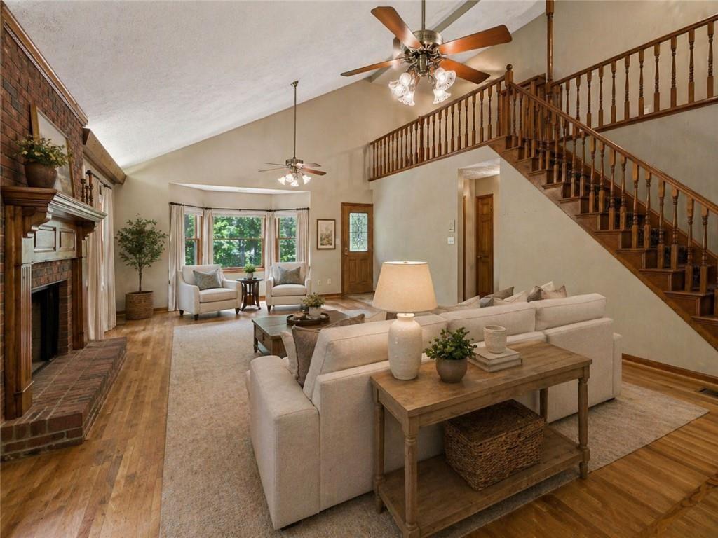 13597 Woolsey Road Hampton, GA 30228 - Photo 9 of 87 a living room with furniture a fireplace and a chandelier