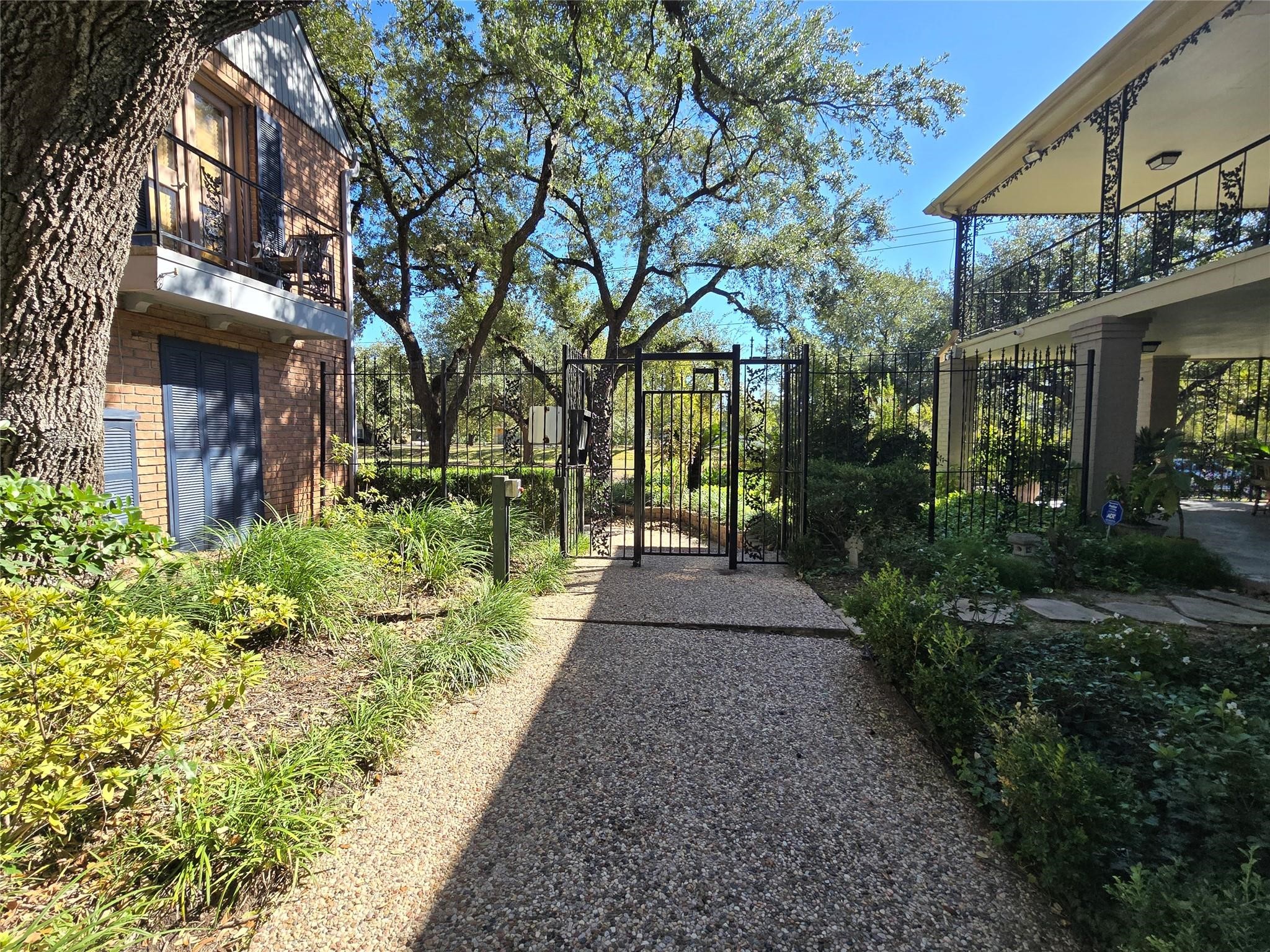 11550 Chimney Rock Road, Unit 312 Houston, TX 77035 - Photo 17 of 18 a view of a pathway with house on both side
