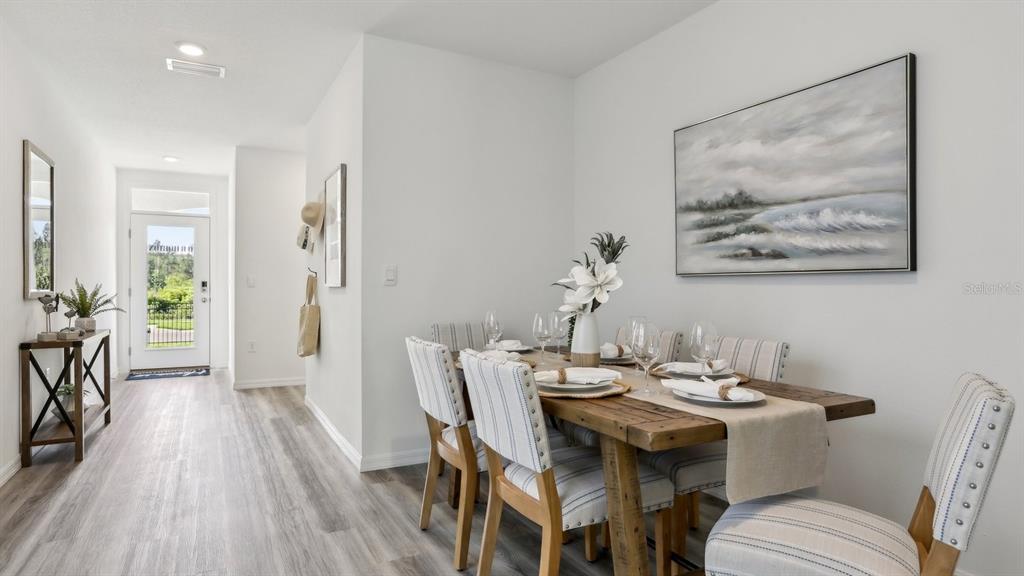 1046 Spotted Egret Loop Ruskin, FL 33570 - Photo 11 of 37 a view of a dining room with furniture window and wooden floor