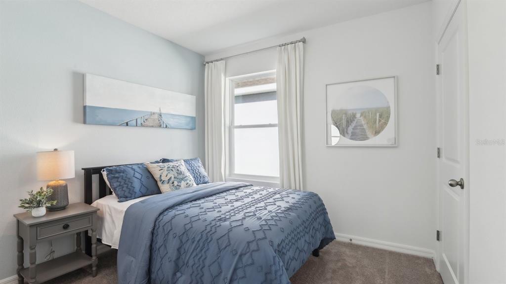 1046 Spotted Egret Loop Ruskin, FL 33570 - Photo 23 of 37 a bedroom with a bed and a window