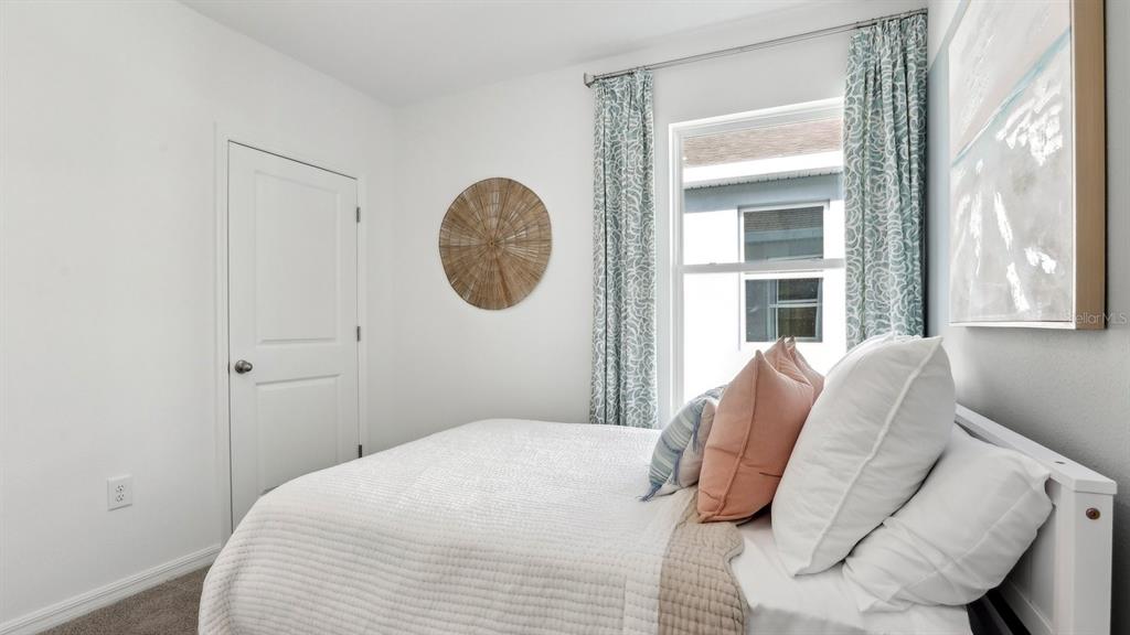 1046 Spotted Egret Loop Ruskin, FL 33570 - Photo 28 of 37 a bedroom with a bed and a window