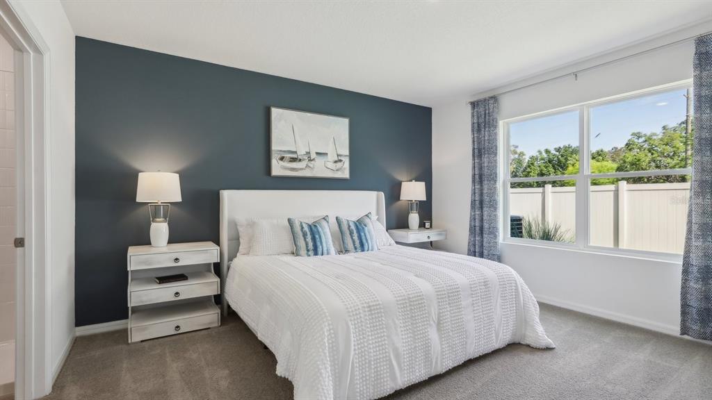 1046 Spotted Egret Loop Ruskin, FL 33570 - Photo 29 of 37 a bedroom with a large bed and a window