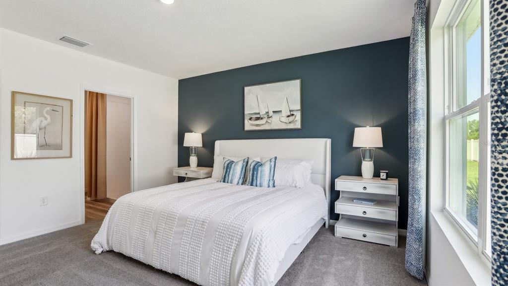 1046 Spotted Egret Loop Ruskin, FL 33570 - Photo 30 of 37 a bedroom with a bed and a window