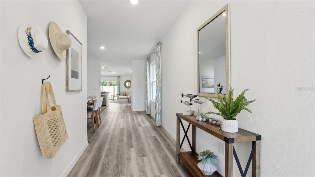 1046 Spotted Egret Loop Ruskin, FL 33570 - Photo 3 of 37 a view of a hallway with furniture and wooden floor