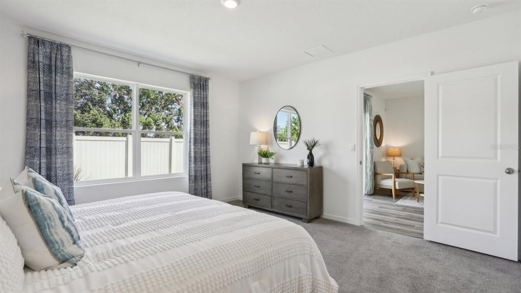 1046 Spotted Egret Loop Ruskin, FL 33570 - Photo 35 of 37 a bedroom with a bed and a dresser