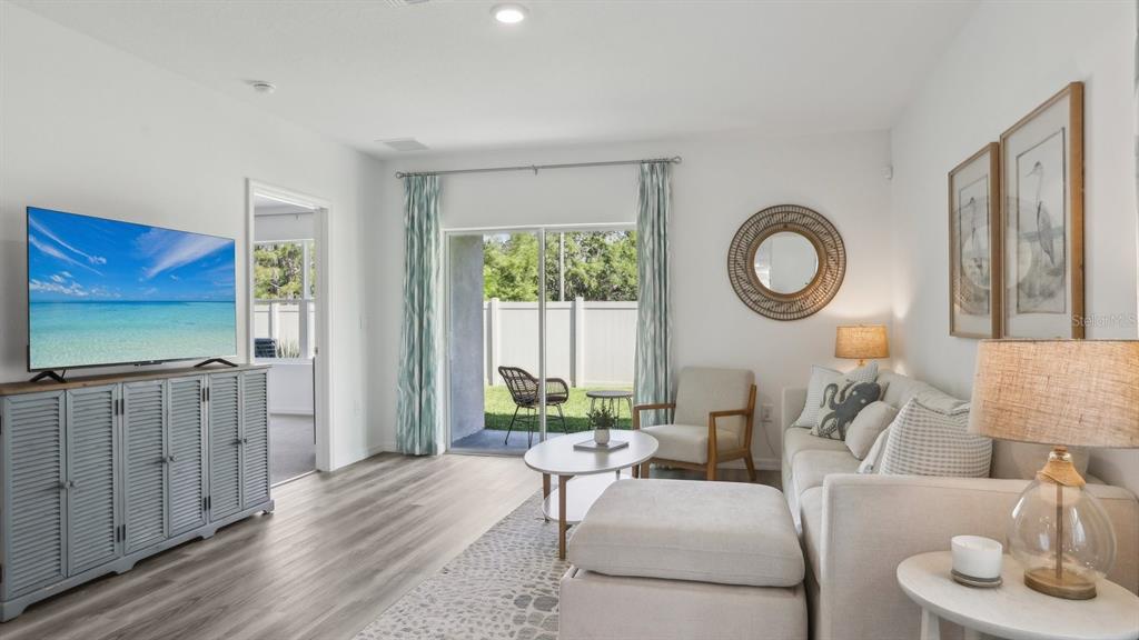 1046 Spotted Egret Loop Ruskin, FL 33570 - Photo 4 of 37 a living room with furniture a window and a flat screen tv