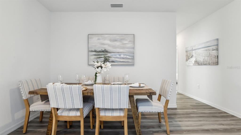 1046 Spotted Egret Loop Ruskin, FL 33570 - Photo 10 of 37 a view of a dining room with furniture and wooden floor