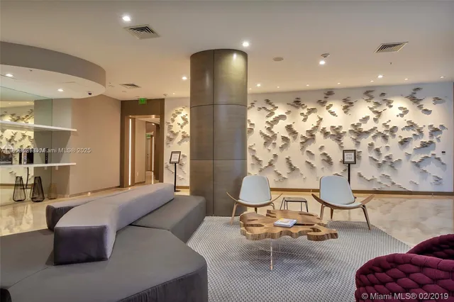 a living room with furniture and a painting