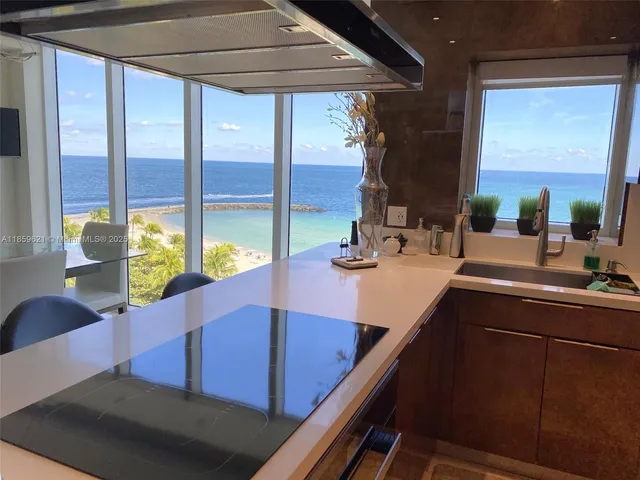 a kitchen with a large window and sink