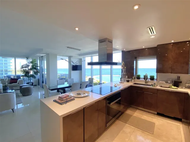 a kitchen with sink cabinets and living room