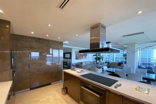 a kitchen with stainless steel appliances a sink a counter top space a large window and stainless steel appliances