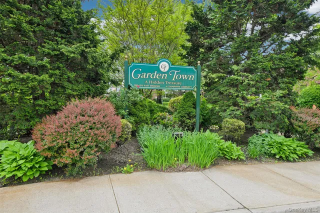 a sign broad in front of flowers