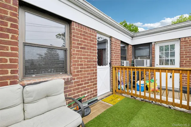 a view of a door and chair and door in the balcony