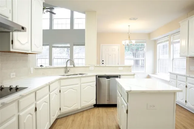 a kitchen with a sink and cabinets