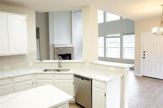 a kitchen with kitchen island sink stove and refrigerator