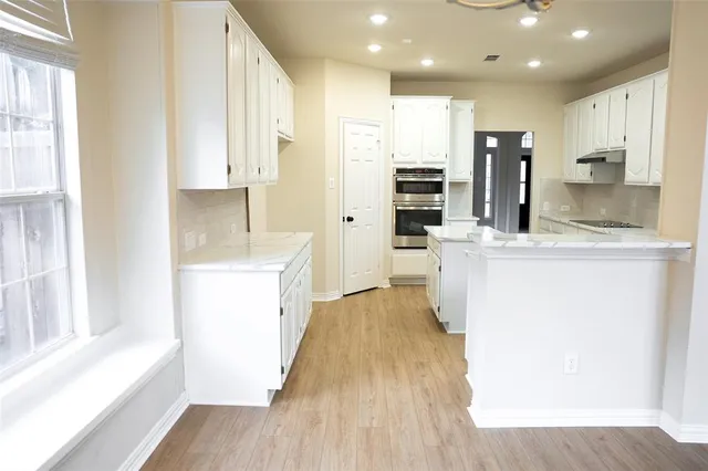 a kitchen with a sink a stove a refrigerator and cabinets