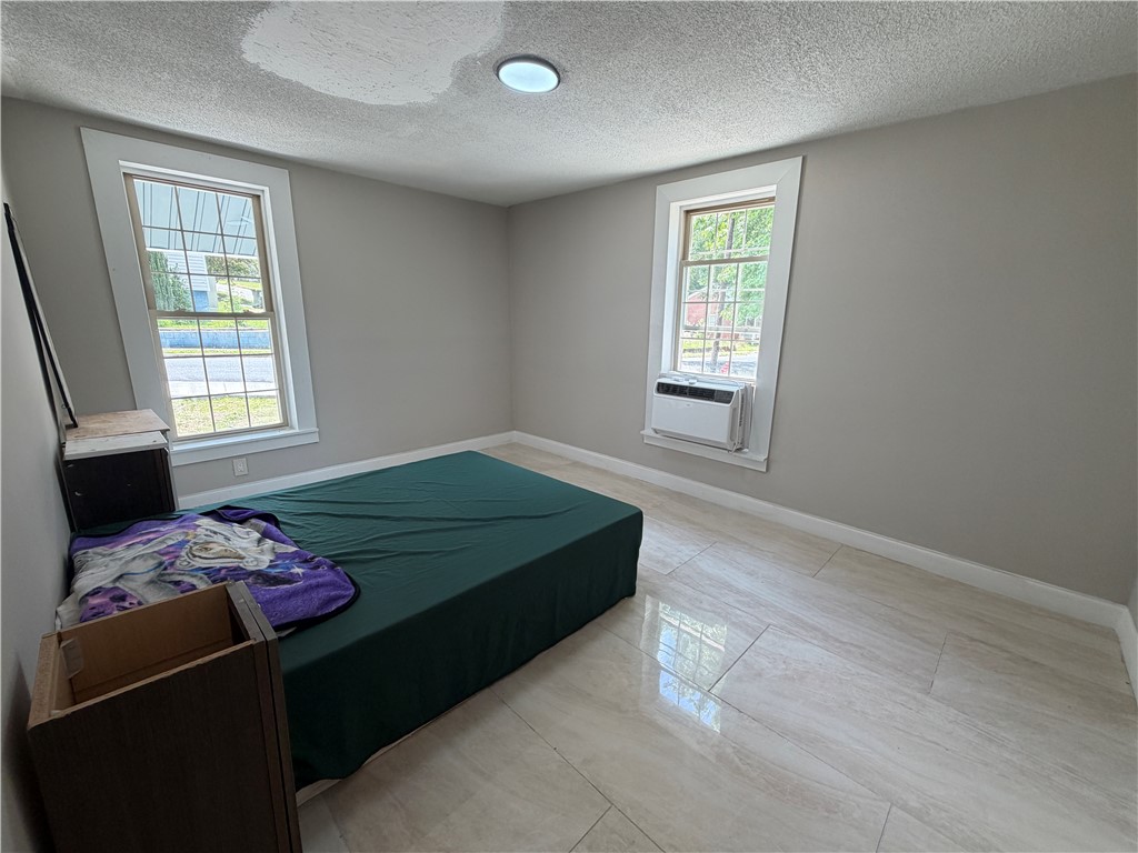 302 Sirrine Street Honea Path, SC 29654 - Photo 13 of 24 A well-lit bedroom featuring durable tile flooring and ample natural illumination from twin windows.